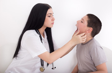 Female doctor examining boy