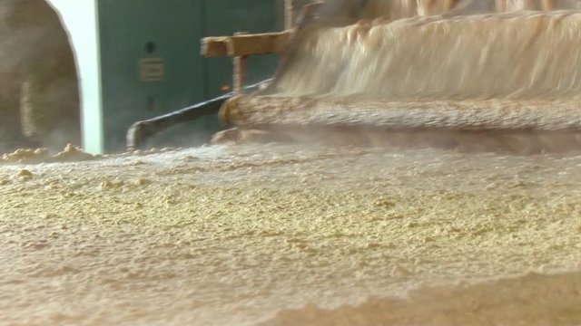 Pulp and Paper Plant. Part of the Papermaking Process. Pouring the Hot Liquid Cellulose From Container Onto Moving Conveyer. Close up