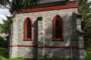 A little stone country church in the beginnings of fall colors.