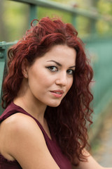 Naklejka premium Beautiful young woman with red hair in the park