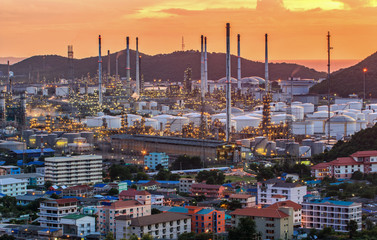 Obraz premium Oil Refinery factory in the sunset , petrochemical plant , Petroleum. and city around area
