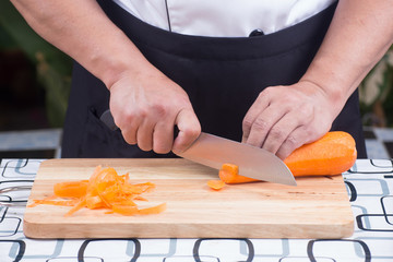 Chef is cutting carrots