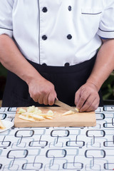 Chef is cutting baby corn
