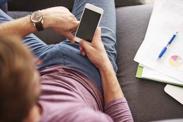 White smart phone in hands of man