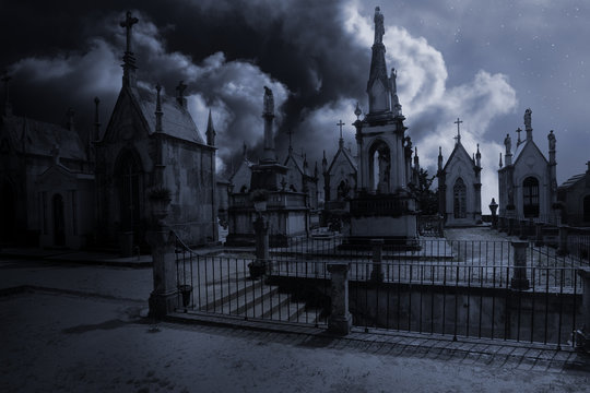 Spooky moonlit old european cemetery