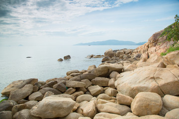 Fototapeta na wymiar rocks on the sea shore with clouds