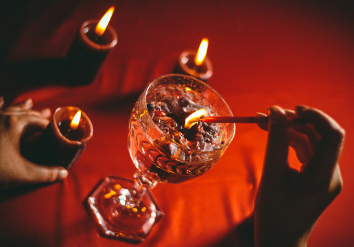 witch holds candle love spell on ritual