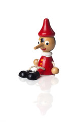 Pinocchio liar doll with big nose isolated on background