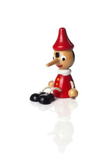 Pinocchio liar doll with big nose isolated on background