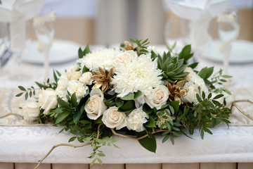 Beautiful wedding restaurant for marriage. White decor for bride and groom. Colorful decoration for celebration. Beauty bridal interior. Bouquet and flowers in hall