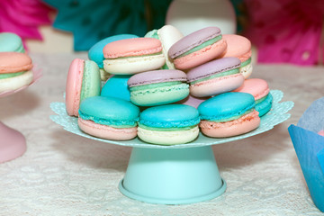 Sweet colorful macaroons in vase on the table. Candy bar backgroud