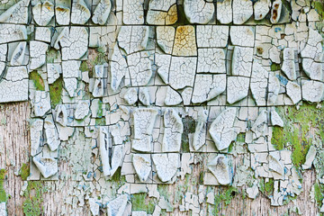 old, weathered boards with peeling paint.