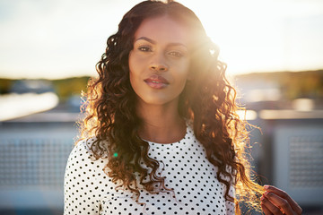 Fototapeta premium Dreamy young woman backlit by the rising sun