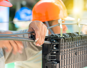 Technicians are install cabinet on fiber optic cable.