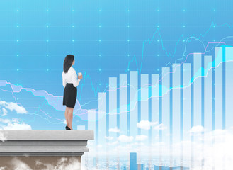 Woman with coffee on rooftop examining stats