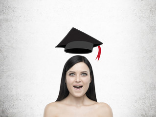 Amazed girl with levitating graduation hat