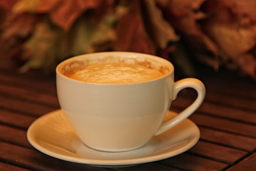 cup of coffee cappuccino on wooden table . Soft focus vintage picture