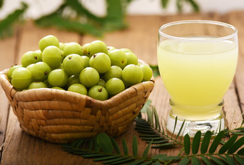 Indian gooseberry juice on the wooden floor