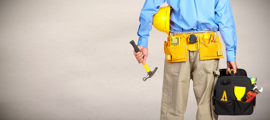 Construction worker with helmet and hammer.