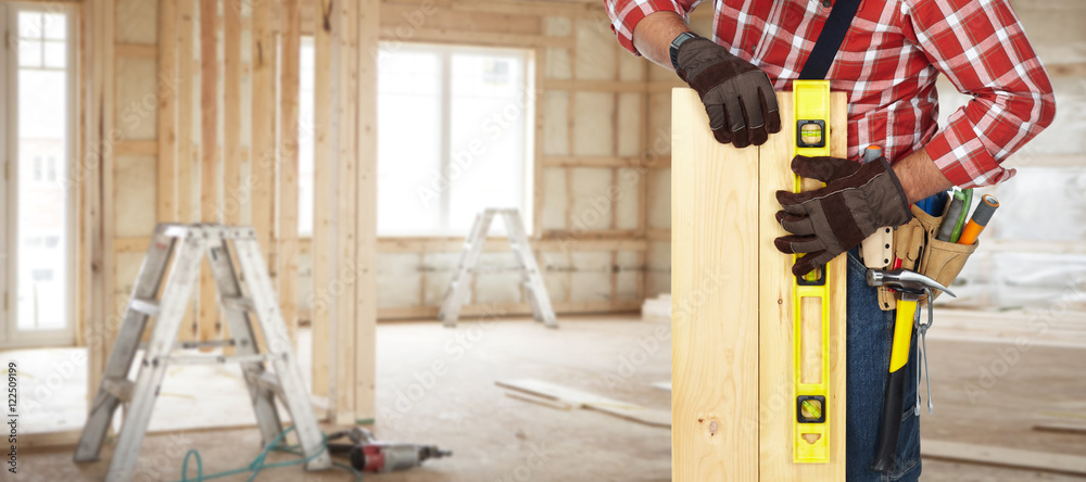 Wall mural builder with level and wooden planks.