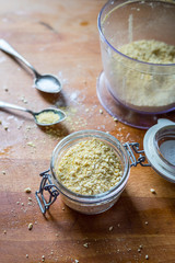 Vegan Parmesan Cheese with Garlic on Wooden Background
