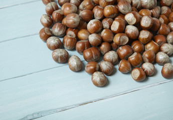 Whole hazel nuts arranged on a blue wood background to form a page header