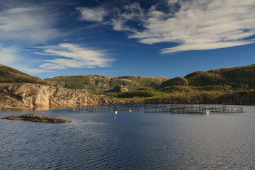 Fish farm at Helgeland under a blue sky