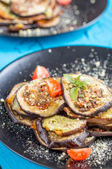 Healthy Сasserole with Baked Sweet Potato, Eggplant and Vegan Parmesan on Blue Wooden Background