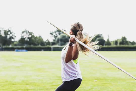 Young woman throwing javelin