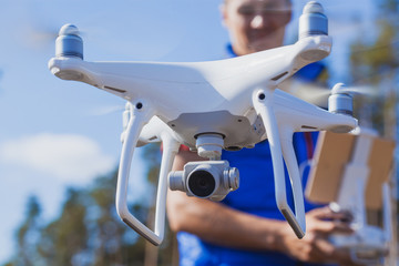 Flying the copter. Remote control in a man's hands.