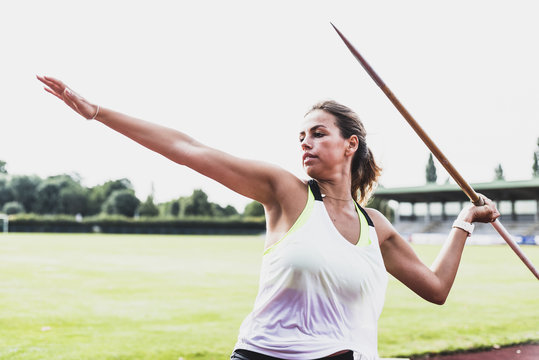 Young woman throwing javelin