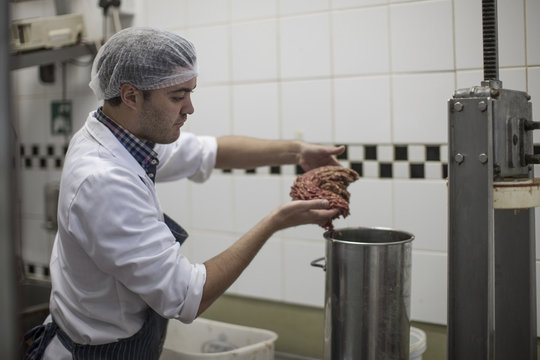 Butcher processing minced meat in butchery