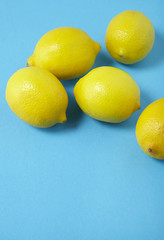 Lemons on a bright blue background forming a page border