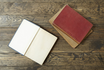 An open note book on an old wooden desk top background