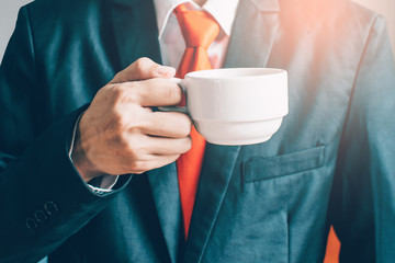 Businessman holding a cup of coffee