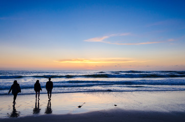 Fototapeta na wymiar People watching ocean sunset