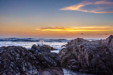 Ocean sunset with rocky foreground