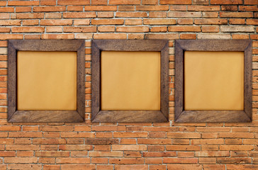 Wooden picture frame on red brick wall background