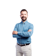 Fototapeta premium Hipster man in blue denim shirt, studio shot, isolated