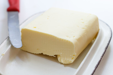 farm butter on a butter dish with a knife