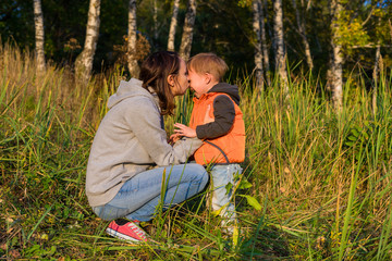 Fototapeta premium Mom hugging her son, soothe a crying baby
