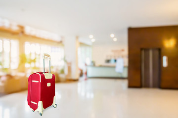 colorful suitcase with hotel lobby