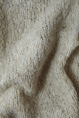 A full page of soft beige knitted sweater background texture