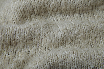 A full page of soft beige knitted background texture