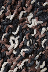 A full page of neutral toned chunky knitted fabric background texture