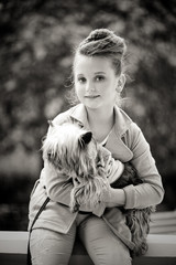 Charming little girl holds fluffy dog