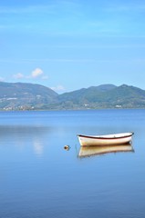 Naklejka na ściany i meble Little boat on a lake