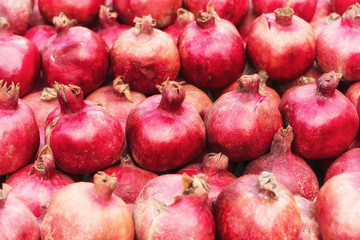 Ripe pomegranates on the market, nature fruit background, closeup