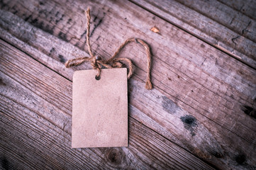 Note paper on wood background,soft focus,vintage tone.