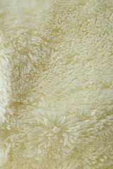 A full page of cream fake fur fabric background texture
